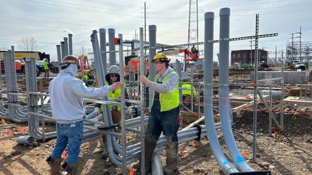 Three Electricians at a job site under construction